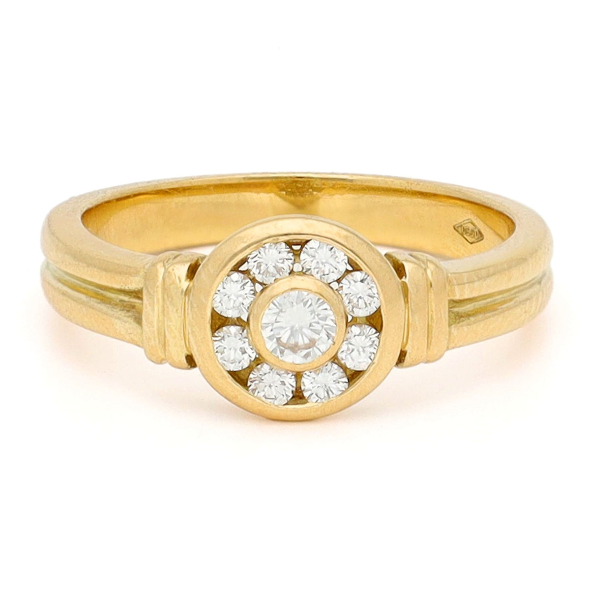 A yellow gold brilliant cut diamond rubover set cluster ring