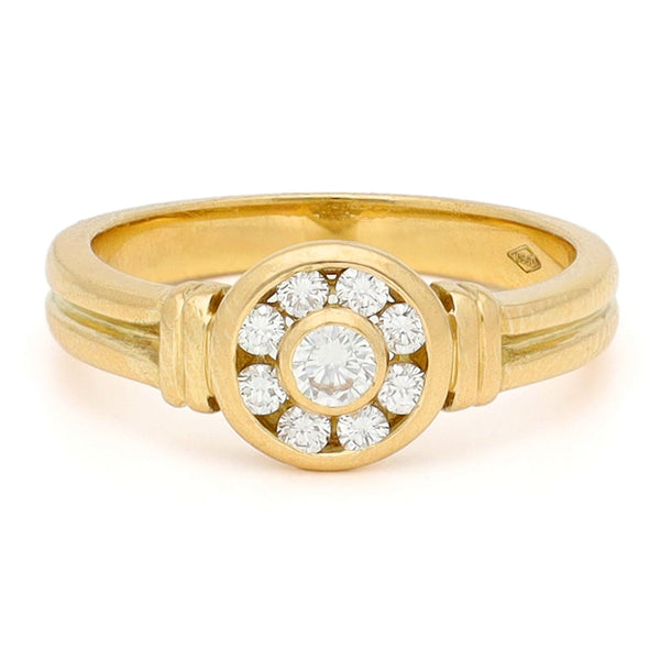 A yellow gold brilliant cut diamond rubover set cluster ring