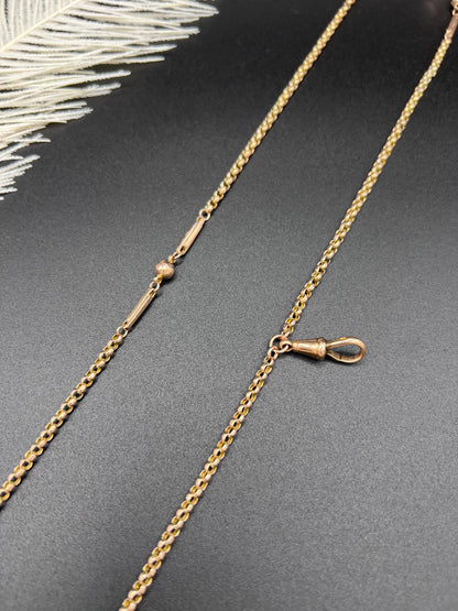 A long rose gold chain necklace with a dog clip clasp