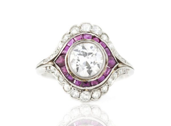 Vintage 3ct Diamond and Ruby Cluster Ring; 3.00ct diamond surrounded by 0.40cts rubies and 2.00cts diamonds, in platinum, Circa 1930's