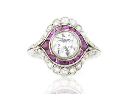 Vintage 3ct Diamond and Ruby Cluster Ring; 3.00ct diamond surrounded by 0.40cts rubies and 2.00cts diamonds, in platinum, Circa 1930's