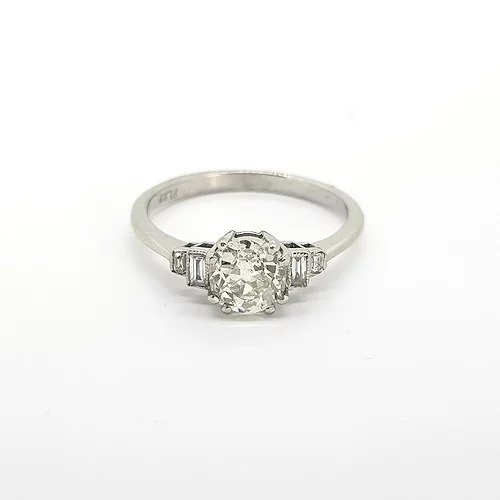 Vintage Old Cut Diamond Solitaire Engagement Ring in Platinum; 0.91 carat old-cut diamond with stepped baguette-cut diamonds to the shoulders