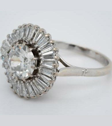 Old Cut Diamond Ballerina Cluster Ring; central 1.80 carat old European-cut diamond surrounded by 1.50 carats of tapering baguette-cut diamonds