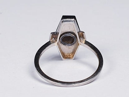 Art Deco French Old Cut Diamond and Onyx Lozenge Plaque Ring; hexagonal ring with central 0.25ct old cut diamond on a matt ground with a fine onyx border. Set in white gold, Circa 1925