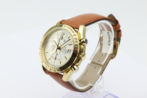 Omega Speedmaster 39mm Automatic Chronograph 18ct Yellow Gold, Silver and white baton dial, date indicator at 3, small seconds at 9, on brown leather strap.