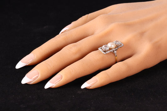 A diamond and pearl elongated plaque ring in yellow gold and platinum, modelled on a hand