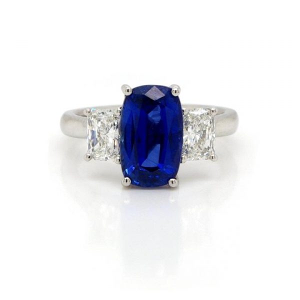 Sapphire and Diamond Trilogy Ring in Platinum, 3.61 carat oval faceted sapphire flanked to either side by a GIA certified radiant cut diamond