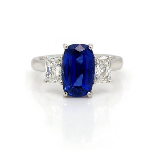 Sapphire and Diamond Trilogy Ring in Platinum, 3.61 carat oval faceted sapphire flanked to either side by a GIA certified radiant cut diamond