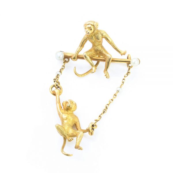 Art Deco 18ct Yellow Gold Monkey Brooch with Pearls; novelty "Monkey Around" brooch crafted from 18ct yellow gold with textured detailing and accented with two pearls. Made in France, Circa 1920