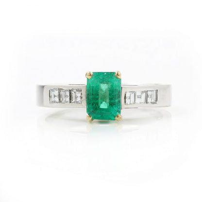 Vintage Emerald Cut Colombian Emerald and Diamond Ring; central 0.90ct certified Colombian emerald-cut emerald flanked by princess-cut diamond set shoulders, in 18ct white gold. Circa 1980s-1990s. With GCS certificate