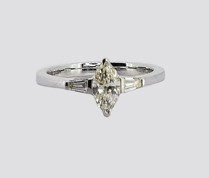 0.57ct Marquise Cut Diamond Engagement Ring; 0.57 carat marquise-cut diamond flanked by 0.21cts tapered baguette-cut diamonds, in 18ct white gold