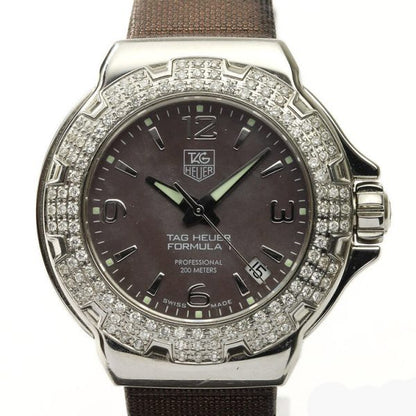Tag Heuer Formula 1 Ladies Sparkling Diamond Bezel Mother of Pearl Dial Watch; Ref. WAC1217, 36mm stainless steel case with original diamond bezel, brown mother of pearl dial, four Arabic numerals, date indicator, screwdown crown and sapphire crystal, Quartz movement, on a TAG Heuer brown satin/leather strap with Tag Heuer buckle