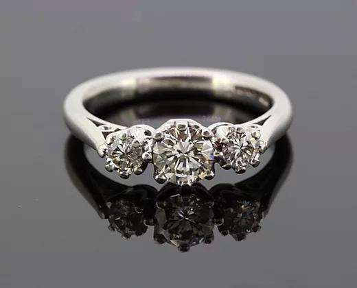 Diamond Three Stone Ring; A classic diamond trilogy ring, set with three round cut diamonds totaling 0.75 carats, eight-claw set, mounted in platinum.