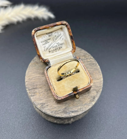 A three stone emerald and diamond ring in yellow gold and platinum
