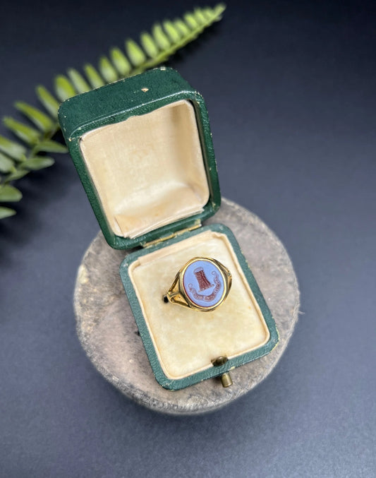 A yellow gold sardonyx signet ring with a seal engraved crest, in a ring box