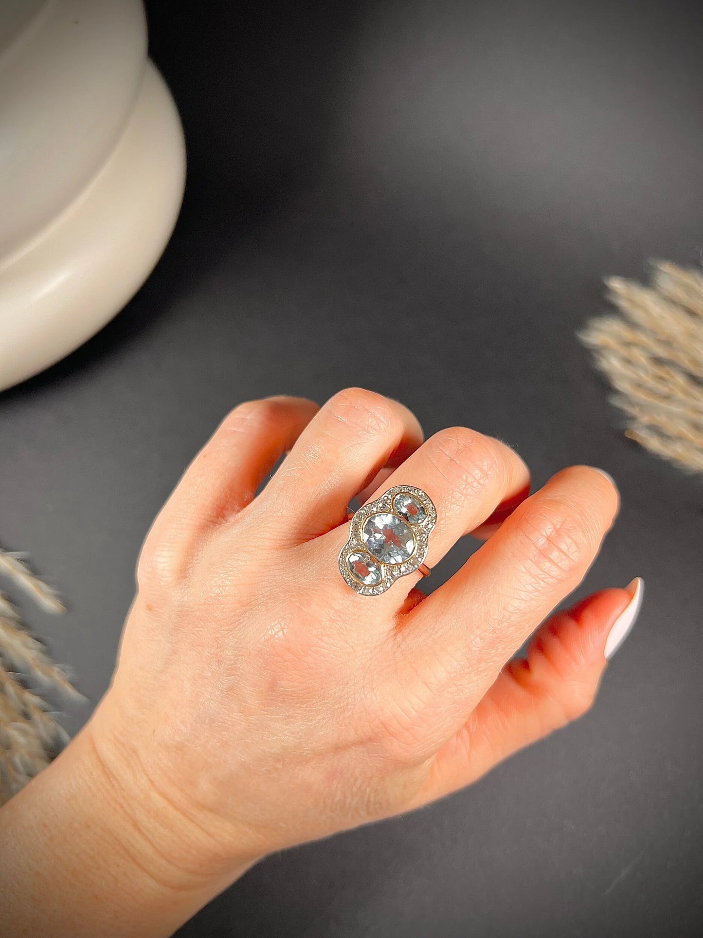 An aquamarine and diamond cocktail cluster ring, modelled on a hand