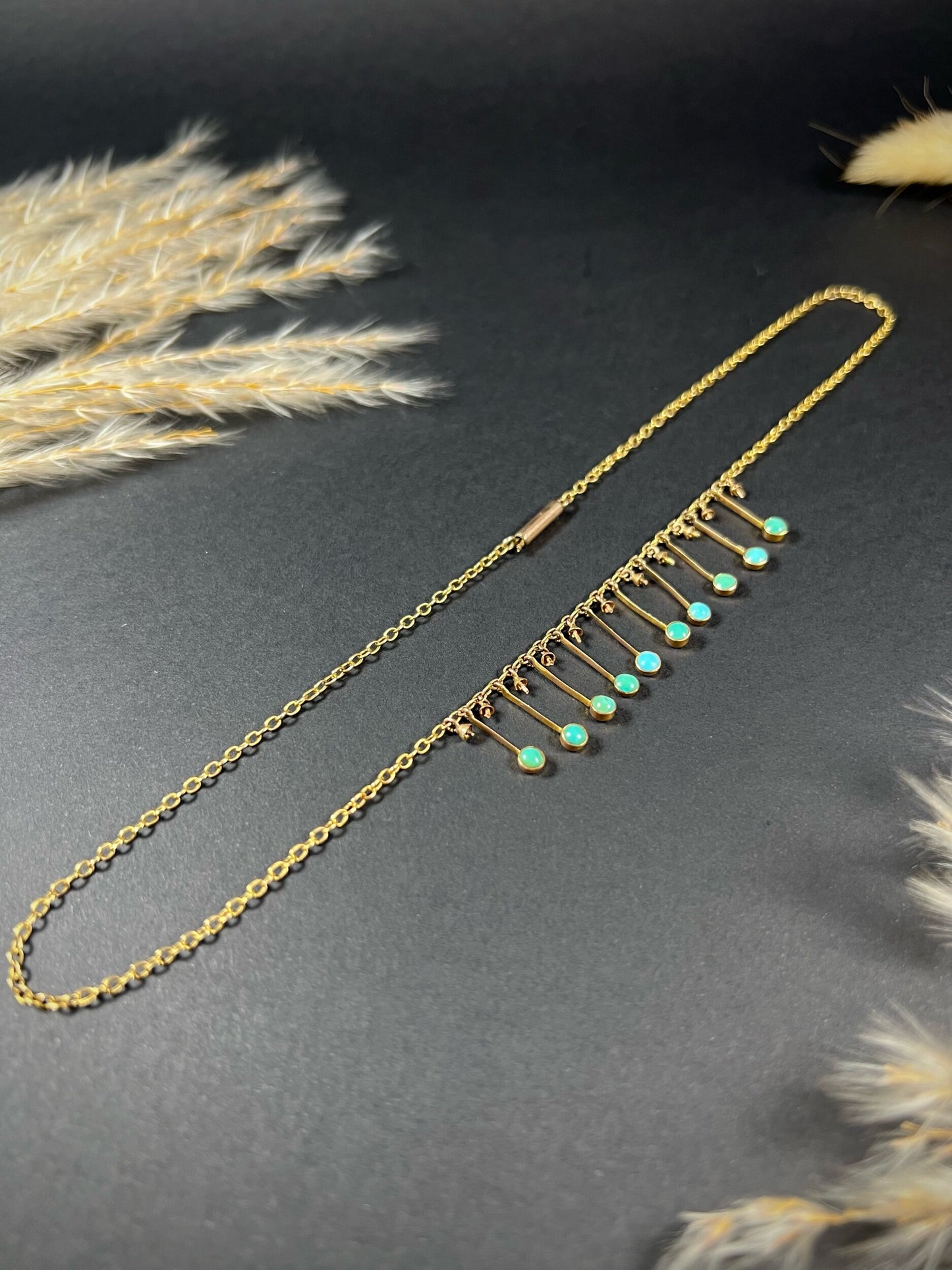 A gold negligee pendant necklace with turquoise drops