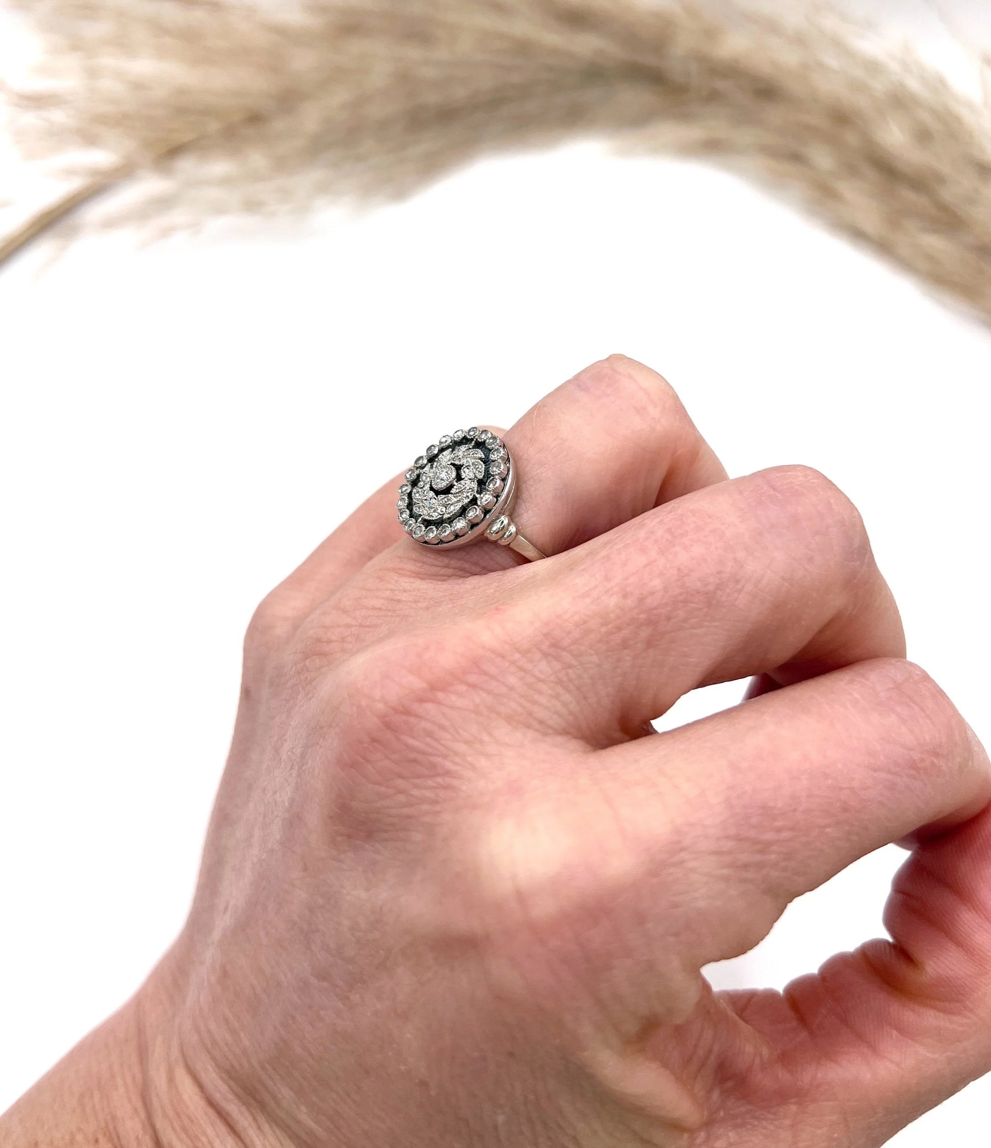 A diamond and dark blue enamel fancy cluster ring in white gold, modelled on a hand