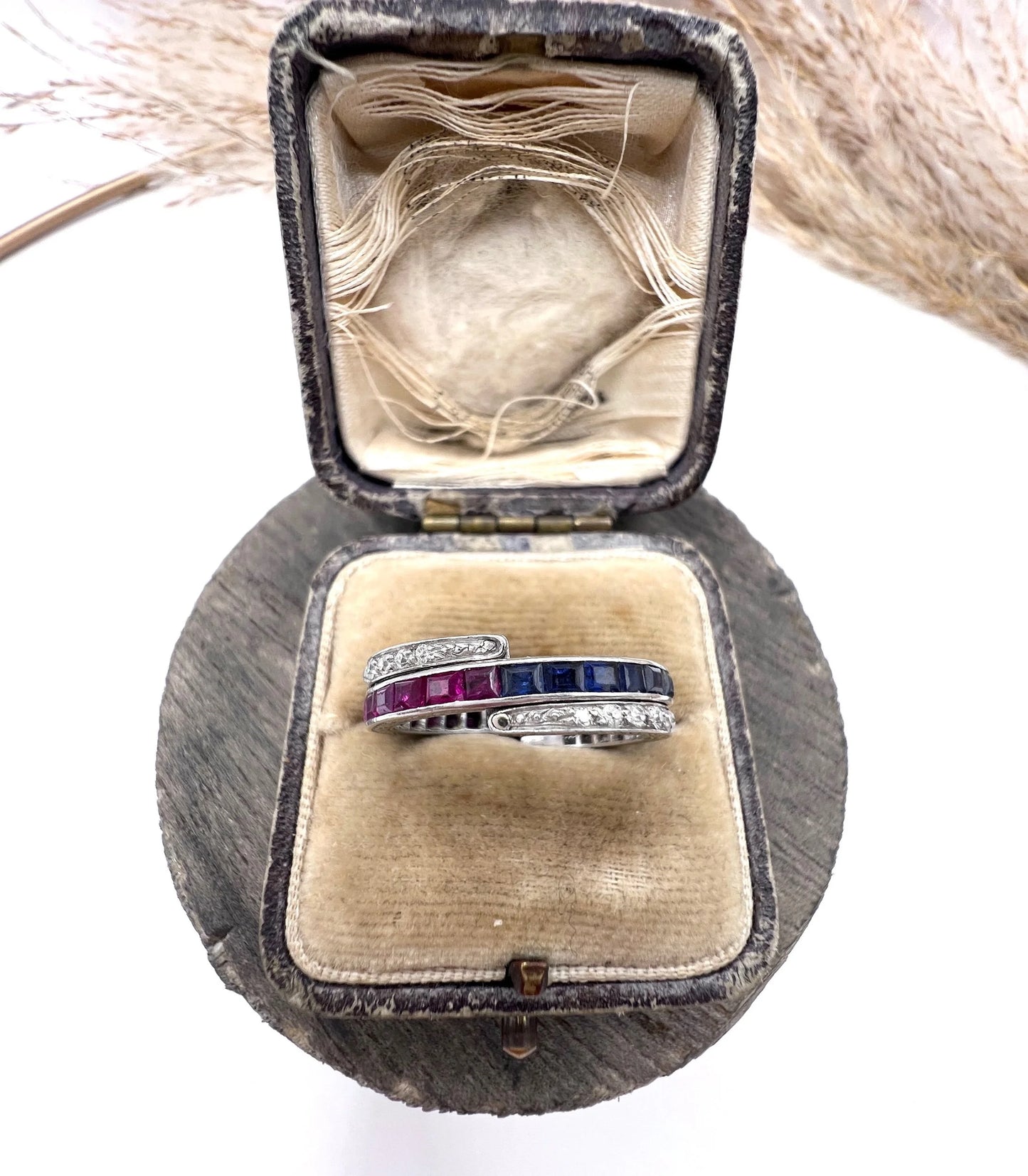 A platinum night and day flip band ring set with diamonds, sapphires and rubies, in a ring box