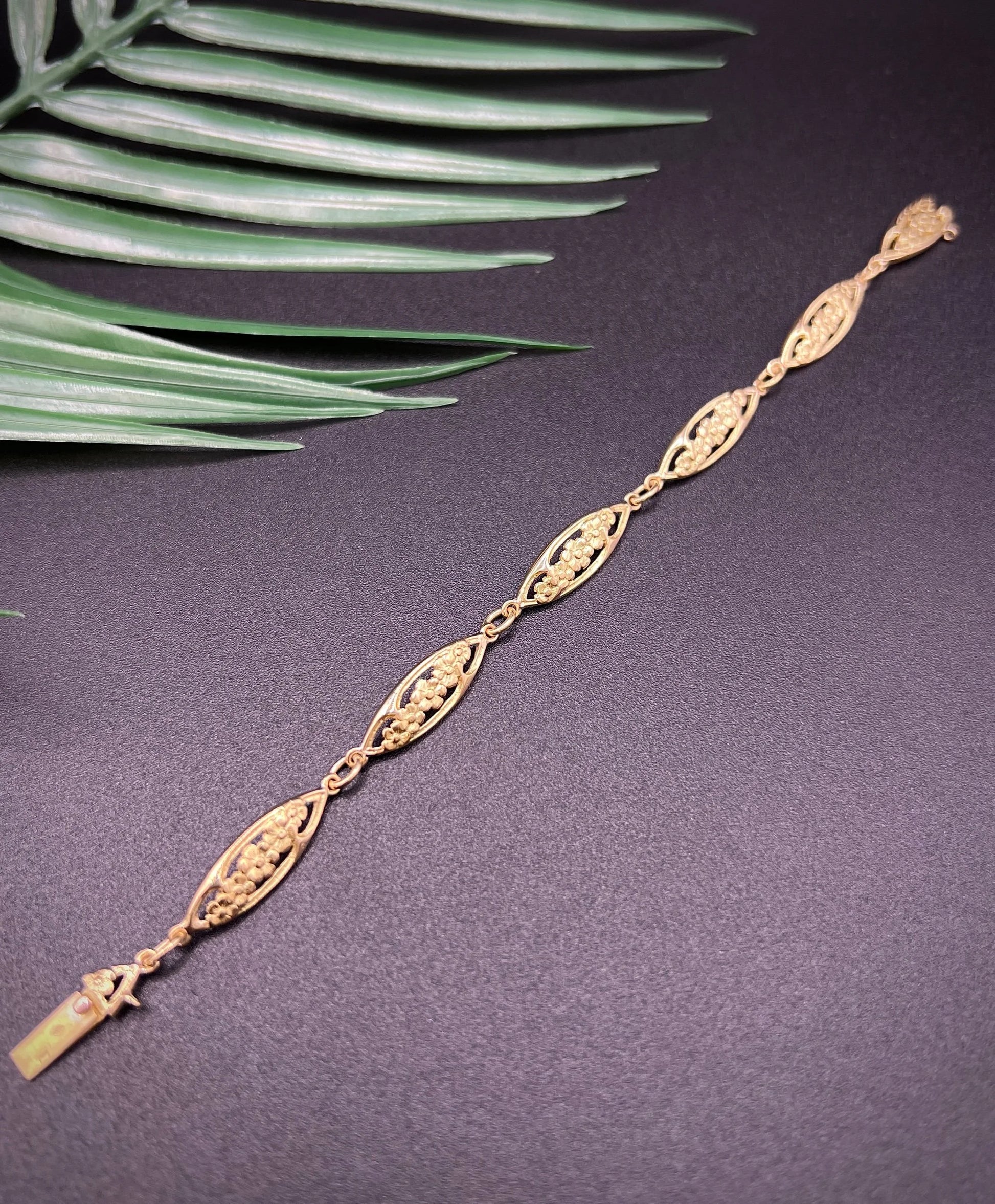 A yellow gold floral link bracelet