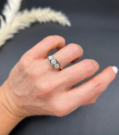 A three stone diamond crossover ring, modelled on a hand