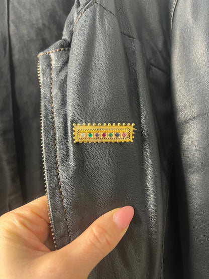 A yellow gold multi-gemstone and diamond acrostic brooch, modelled on a black jacket