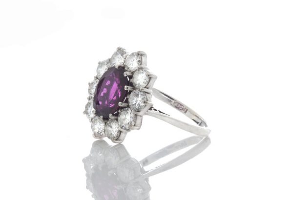 Vintage 1.5ct Thai Ruby and Diamond Cluster Ring in 18ct White Gold; 1.50 carat oval ruby surrounded by 1.00cts sparkling diamonds, in 18ct white gold. Circa 1970's.