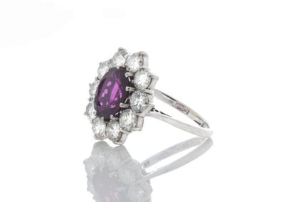 Vintage 1.5ct Thai Ruby and Diamond Cluster Ring in 18ct White Gold; 1.50 carat oval ruby surrounded by 1.00cts sparkling diamonds, in 18ct white gold. Circa 1970's.