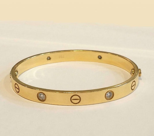 Cartier Love Bangle with Diamonds; 18ct yellow gold Cartier love bangle set with four brilliant-cut diamonds