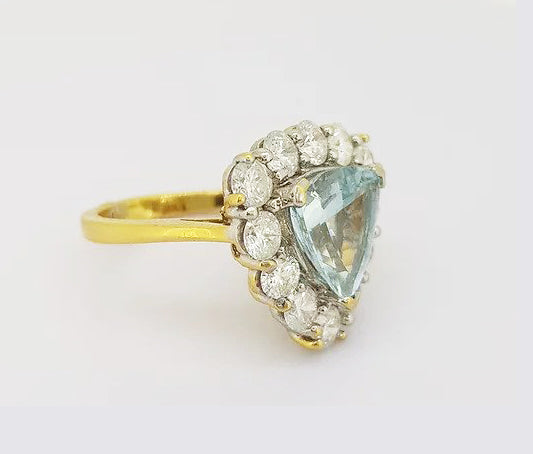 Aquamarine and Diamond Triangular Cluster Ring; 2.00ct triangle-shaped aquamarine set with a surround of 1.50cts brilliant cut diamonds, 18ct yellow gold.