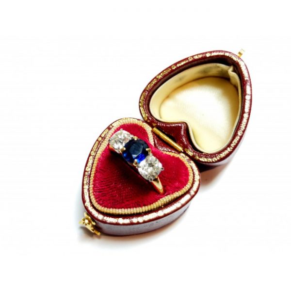 Vintage Sapphire and Old Cut Diamond Three Stone Ring, central 1.17ct sapphire flanked by old-cut diamonds, mounted in 14ct yellow gold, with white gold settings, Circa 1960