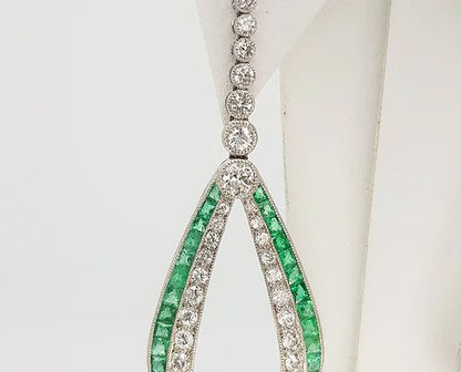 Pair of Contemporary Emerald, Diamond and Platinum Drop Earrings; set with calibre-cut emeralds and round brilliant-cut diamonds, in platinum