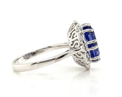 Tanzanite and Diamond Cluster Dress Ring; central 4.56 carat oval faceted tanzanite with brilliant and baguette-cut diamond surround, in 18ct white gold