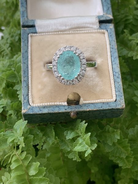 Paraiba Tourmaline and Diamond Cluster Ring in 18ct White Gold; 3.73 carat oval faceted aqua/greenish-blue Paribia tourmaline
