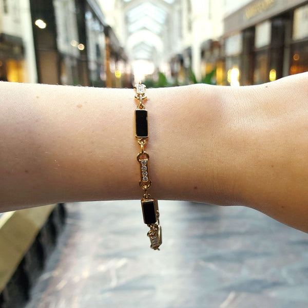 Van Cleef and Arpels onyx and diamond chain link bracelet in gold.