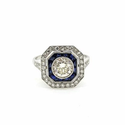 Sapphire and Diamond Cluster Target Ring; central 0.80 carat diamond surrounded by calibre-cut sapphires and outer border of diamonds, diamond set shoulders, in 18ct white gold