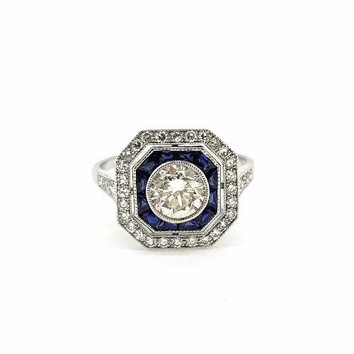 Sapphire and Diamond Cluster Target Ring; central 0.80 carat diamond surrounded by calibre-cut sapphires and outer border of diamonds, diamond set shoulders, in 18ct white gold