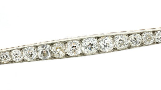 Art Deco Old Cut Diamond Bar Brooch; set with 1.20 carats of graduating old-cut diamonds. Mounted in platinum and backed with 18ct yellow gold. Circa 1920s