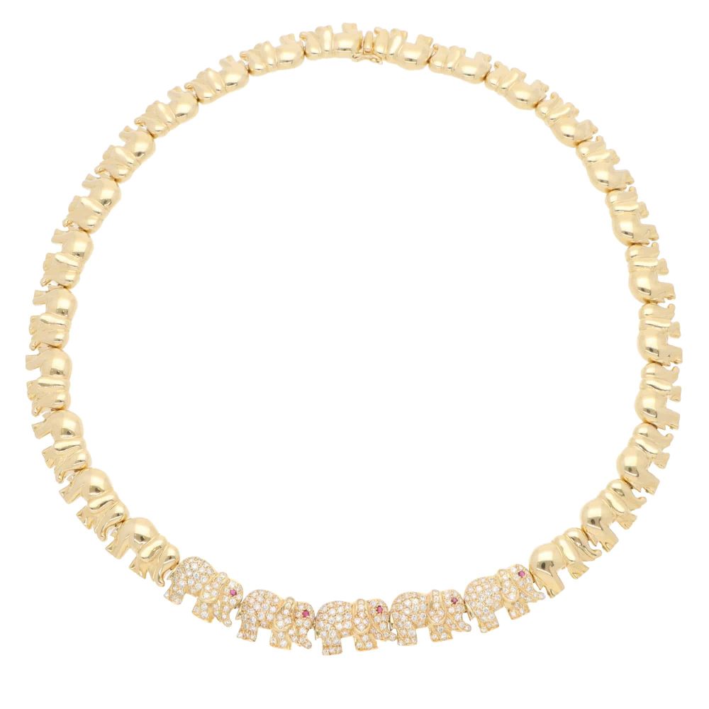 Diamond and ruby walking elephant necklace in gold.