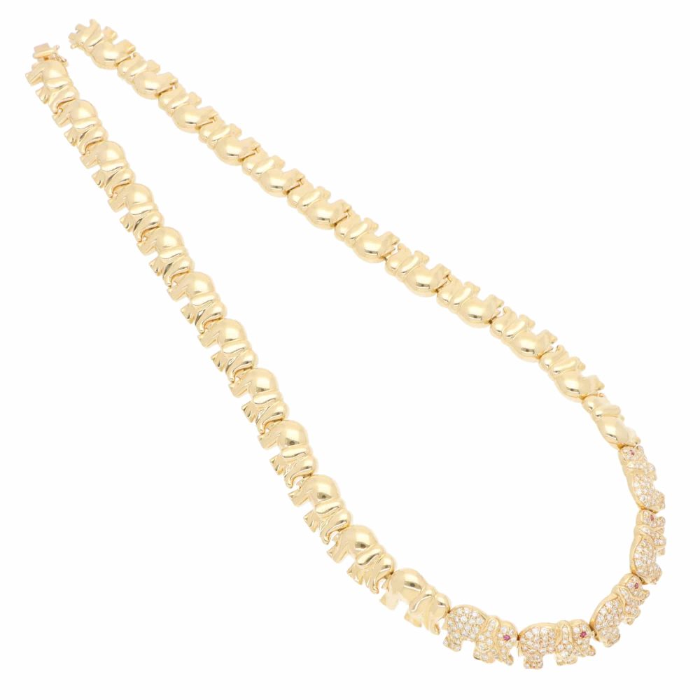 Diamond and ruby walking elephant necklace in gold.