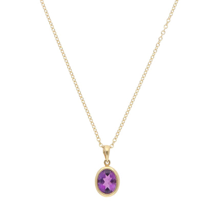 A yellow gold amethyst pendant on a gold chain, on a white background