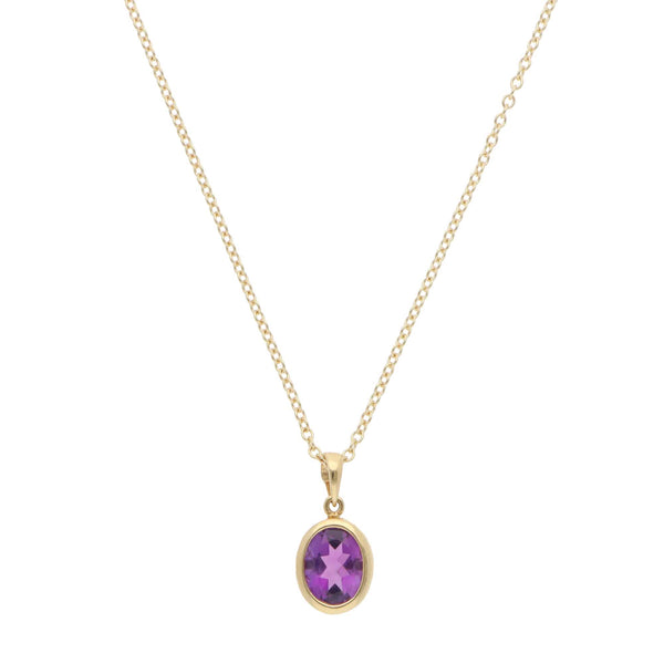 A yellow gold amethyst pendant on a gold chain, on a white background