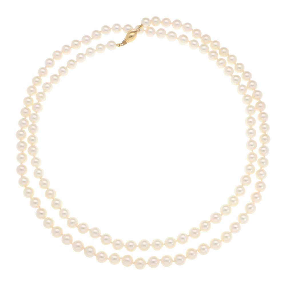 Akoya pearl necklace with a gold barrel clasp.