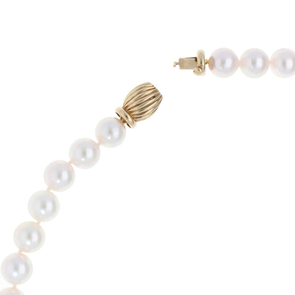 Akoya pearl necklace with a vintage ridged barrel clasp in gold.