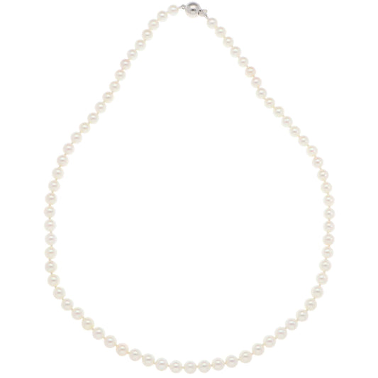 A white pearl single row necklace with a white gold clasp, on a white background