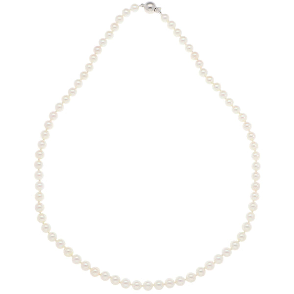 A white pearl single row necklace with a white gold clasp, on a white background