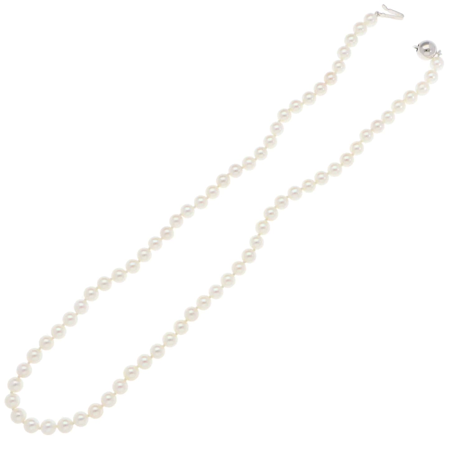 A white pearl single row necklace with a white gold clasp, on a white background