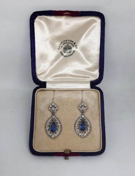 Belle Epoque Sapphire and Diamond Drop Earrings; 2.50cts pear-shaped sapphires with old-cut diamond surround and floral tops, in openwork platinum with millegrain edging
