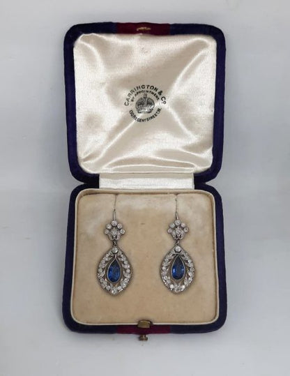 Belle Epoque Sapphire and Diamond Drop Earrings; 2.50cts pear-shaped sapphires with old-cut diamond surround and floral tops, in openwork platinum with millegrain edging