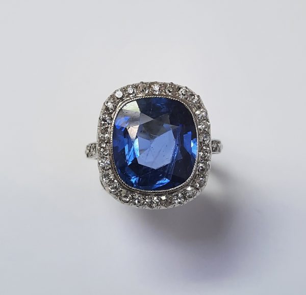 Natural Ceylon Sapphire and Old Cut Diamond Cluster Ring; cornflour blue 5ct certified natural unheated cushion cut sapphire with old-cut diamond surround and shoulders, in 1930s platinum handmade mount